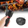 A hand holding a black electric rotisserie motor with a grill and a chicken cooking in the background. Produktbild-Vorschau