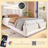 A bed with LED lighting and a smartphone app interface shown. Produktbild-Vorschau