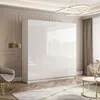 A modern living room with a large white high-gloss wardrobe. Produktbild-Vorschau