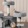A close-up view of a multi-level cat tree with hanging plush balls and a small archway. Produktbild-Vorschau