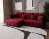 A modern living room with a red sectional sofa, abstract art on the wall, and a large rug. Produktbild-Vorschau