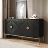 A black sideboard with gold accents and legs, displayed in a room setting with curtains and artwork. Produktbild-Vorschau