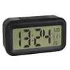 A digital alarm clock with a black casing and a light green display showing the time, date, and temperature. Náhled obrázku produktu