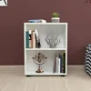 A white bookshelf with two shelves, filled with books and decorative items, placed on a wooden floor against a burgundy wall. Anteprima dell’immagine prodotto