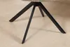 Close-up of the base of a chair with black metal legs on a light-colored floor. Produktbild-Vorschau