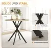 A round dining table with a light wood top and black criss-cross legs, set in a kitchen or dining area. There are inset images highlighting the table's legs and adjustable feet. Produktbild-Vorschau