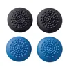 Four controller thumbstick grips, two black and two blue, are arranged in a two-by-two grid against a white background. Produktbild-Vorschau