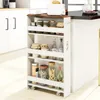 A narrow kitchen cart filled with jars and bottles, placed next to a kitchen counter. Voir les images du produit