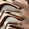 A close-up view of several copper-colored faucets arranged on a textured surface with hexagonal copper tiles. Anteprima dell’immagine prodotto