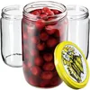 Three glass jars, one filled with red cherries and two empty, are arranged on a white background. A yellow lid with a floral design is placed in the foreground. Produktbild-Vorschau
