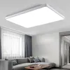 A modern living room with a sectional sofa, coffee table, and curtains, illuminated by a large rectangular ceiling light. Produktbild-Vorschau