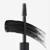 A swatch of black mascara is shown with the applicator brush resting on top, against a white background. Podgląd zdjęcia produktu