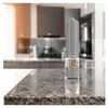 A pepper mill with multi-colored peppercorns sits on a granite countertop in a kitchen setting. Náhľad obrázku produktu