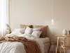 A bedroom with a bed, pillows, and a desk. Produktbild-Vorschau