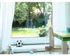 Children's toys on a windowsill with a garden view. Náhled obrázku produktu