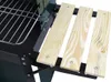 Close-up view of a charcoal grill with wooden shelves. Produktbild-Vorschau