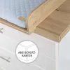 Close-up of a baby changing table with a quilted pad and wooden accents, showing a safety feature. Produktbild-Vorschau