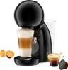 A black Dolce Gusto coffee machine with a latte and an espresso in glasses, and coffee capsules. Podgląd zdjęcia produktu