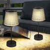 Two solar table lamps are placed on a table next to a couch on a patio. Produktbild-Vorschau