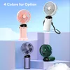 Four different colored portable fans displayed on multi-level platforms against a sky background. Náhled obrázku produktu