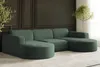 A sectional sofa with a chaise lounge in a dark green ribbed fabric, set against a dark paneled wall and a light rug. Náhled obrázku produktu