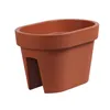 A single terracotta-colored oval balcony planter box is shown against a white background. Anteprima dell’immagine prodotto
