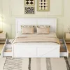A white bed with storage drawers is shown in a bedroom setting. Produktbild-Vorschau