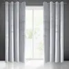 Two light gray curtains are hung on a curtain rod in front of a window. The curtains have a textured appearance. Náhľad obrázku produktu
