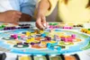 People playing the board game Catan. Produktbild-Vorschau