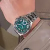 A close-up shot of a man's wrist wearing a silver and green Guess watch. Produktbild-Vorschau