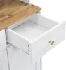 A close-up view of an open drawer on a white cabinet with a wooden countertop. Produktbild-Vorschau