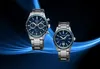 Two Seiko watches are displayed against a dark background with blue light effects. Podgląd zdjęcia produktu