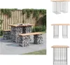 A gabion garden bench and table set on a patio with a wooden fence and greenery in the background. Náhled obrázku produktu