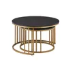 A set of two nesting round coffee tables with black marble-effect tops and gold metal frames, presented against a white background. Voir les images du produit