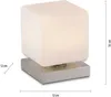 A cube-shaped table lamp with a brushed metal base, shown with dimensions indicated. Anteprima dell’immagine prodotto