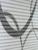 A close-up view of a fabric with a striped pattern and abstract curved lines. Produktbild-Vorschau