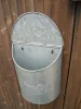A galvanized metal mailbox is mounted on a wooden fence. Produktbild-Vorschau