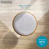 A top-down view of a round, light gray felt seat cushion with a wooden rim, placed on a light brown wooden floor. The image includes text overlays indicating dimensions and washing instructions. Produktbild-Vorschau