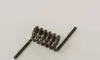 A metal spring with two straight ends on a white background. Produktbild-Vorschau