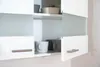 A close-up view of a white kitchen cabinet with open doors, showing some mugs and bowls inside. Produktbild-Vorschau