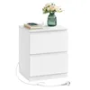 A white, two-drawer nightstand with a vase of flowers and a phone on top, with a power cord extending from the bottom. Produktbild-Vorschau