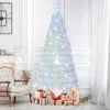A decorated Christmas tree with gifts underneath in a room with a chair and fireplace. Produktbild-Vorschau