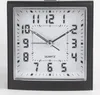 A close-up studio shot of a black analog alarm clock with a white face and silver hands. Produktbild-Vorschau