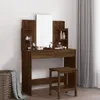 A makeup vanity with a mirror and stool, set against a white wall with grey curtains in the background. A wicker basket with a blanket is on the left. Náhled obrázku produktu