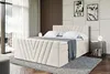 A bedroom scene featuring a large upholstered bed. Produktbild-Vorschau