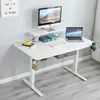 A white adjustable standing desk with a computer monitor, laptop, and accessories. Anteprima dell’immagine prodotto