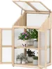 A wooden greenhouse with plants on shelves, shown against a white background. Náhled obrázku produktu