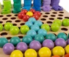 A close-up view of a wooden board game with colorful balls. Produktbild-Vorschau