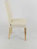 A side view of a cream-colored upholstered dining chair with natural wood legs, set against a plain white background. Voir les images du produit
