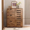 A wooden shoe cabinet with drawers and shelves, placed in a hallway or entryway. Podgląd zdjęcia produktu
